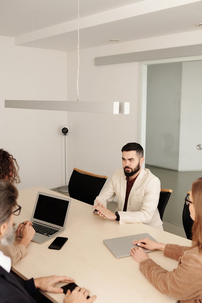 Crafting Captivating Headlines: Your awesome post title goes here A diverse group engaged in a business meeting in a modern office setting.